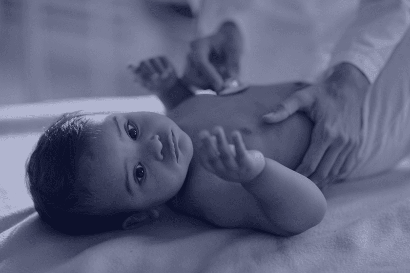 Doctor examining a baby — i-LEAP tackles lead poisoning